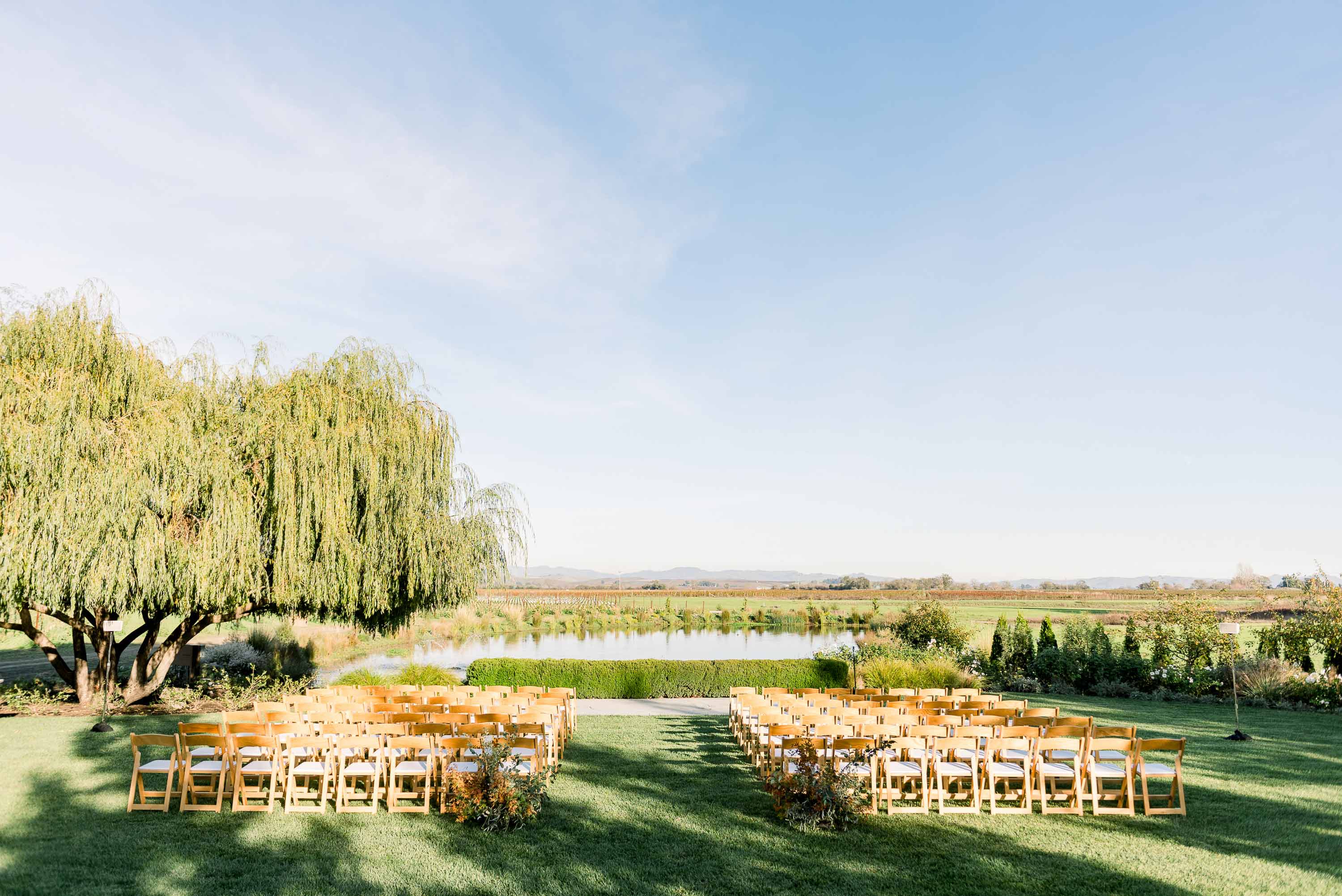 chairs and isle ready for a wedding in front of the lilly pond