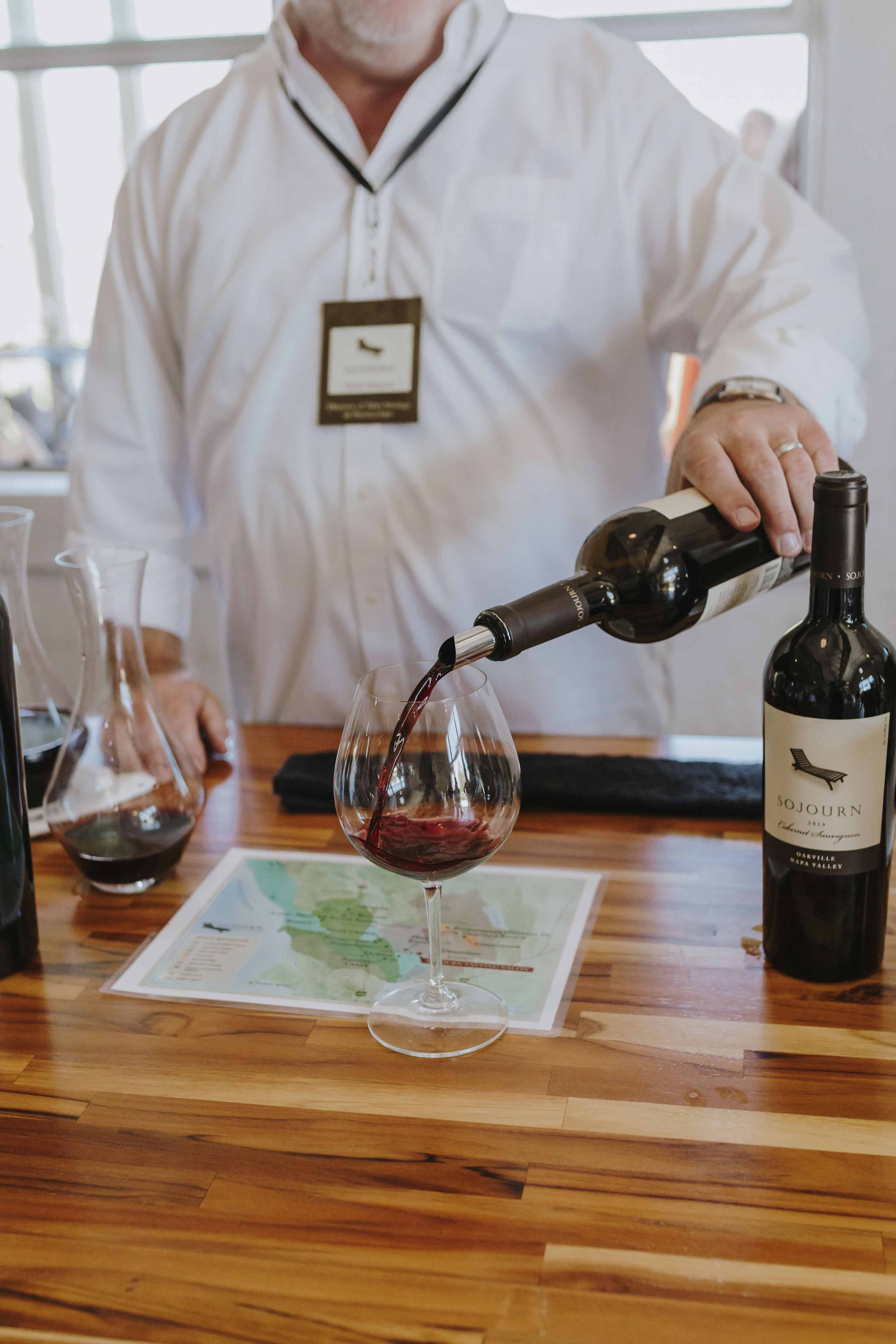 Sommelier pouring a glass of Sojourn cabernet